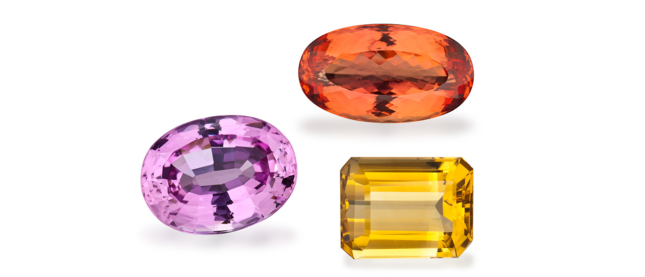 The two November birthstones are topaz (the pink and orange gems) and citrine (the yellow gem).