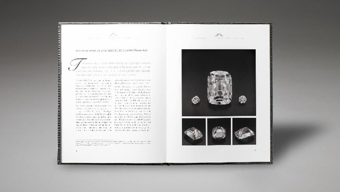 Monograph hard cover book open with diamond images and hard cover slip case, GIA report enclosed.
