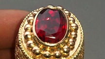 Bright red faceted ruby in a gold ring, from the large and potentially productive Snezhnoe deposit in Tajikistan.