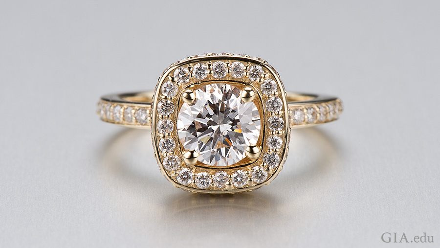 A gold ring designed from a CAD model features the April birthstone with a round center diamond surrounded by small diamonds and a diamond band.