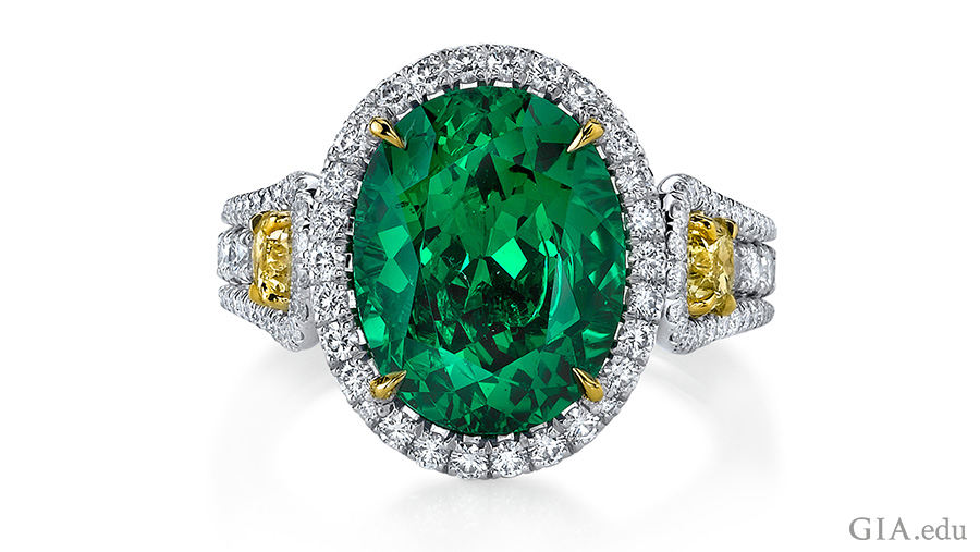 5.55 carat oval cut tsavorite garnet ring set in platinum with two fancy yellow diamonds and 136 round diamonds shows off the January birthstone.