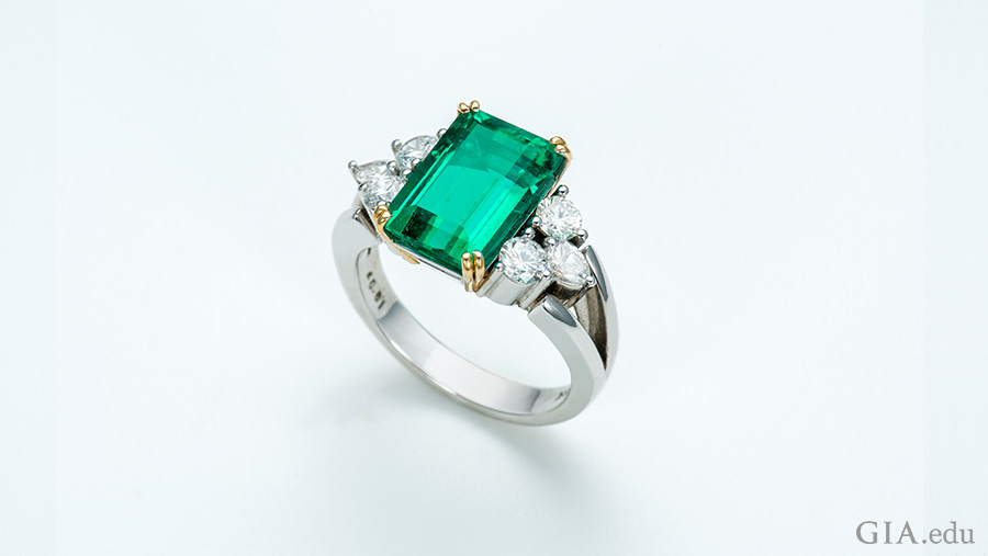  3.69 carat emerald ring flanked by six diamonds shows off the May birthstone.