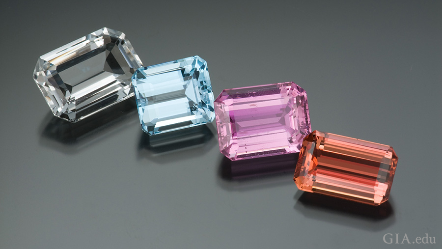 Colorless topaz from Nigeria, light blue topaz from Brazil, purplish-pink topaz from Pakistan, and orange-red topaz from Brazil exhibit the multiple colors of the November birthstone.