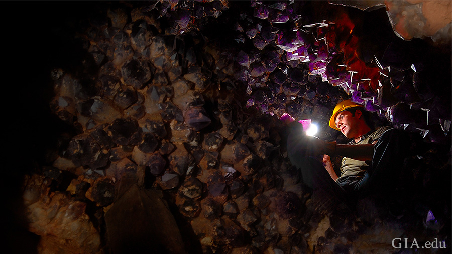 A miner shines a light to reveal thousands of purple amethyst and yellow citrine crystals lining the walls of the Anahí mine in Bolivia, where the November birthstone can be found.